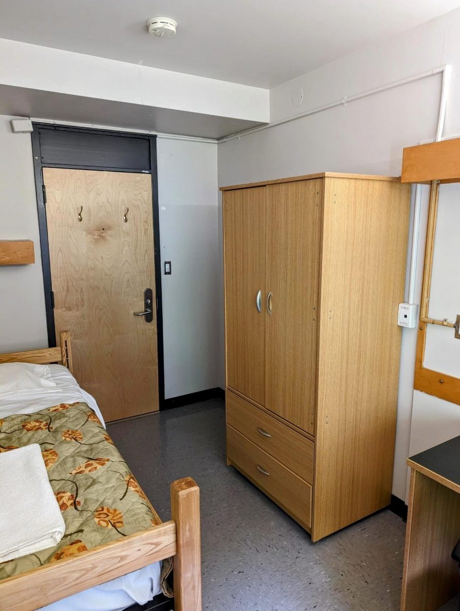 Wetmore Hall single room, showing a bed and a wardrobe.
